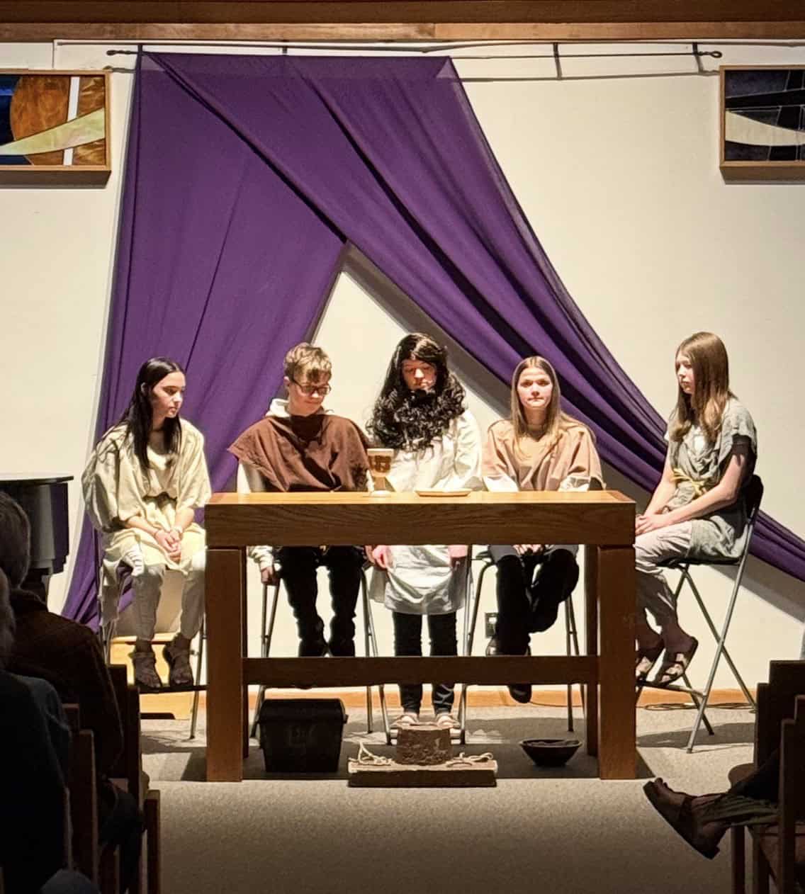 Image of 5 actors acting out the scene of the last supper